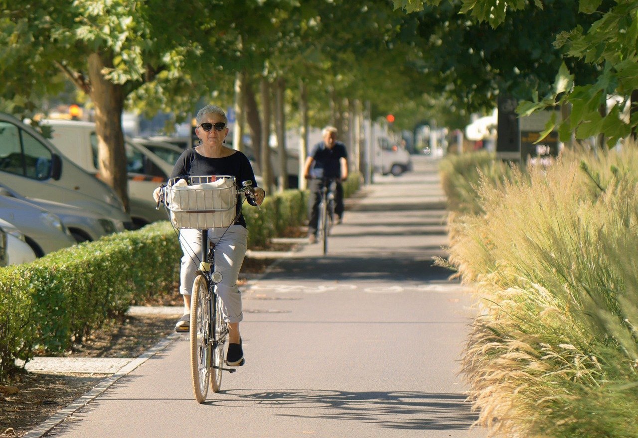 woman, old, cycling, the sidewalk, the street, by bicycle, bike, senior, glasses, outdoor, urban, town, sports, health